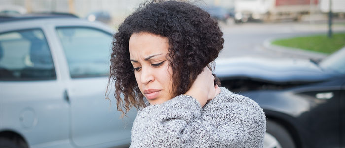 Woman holding neck in pain after an auto accident